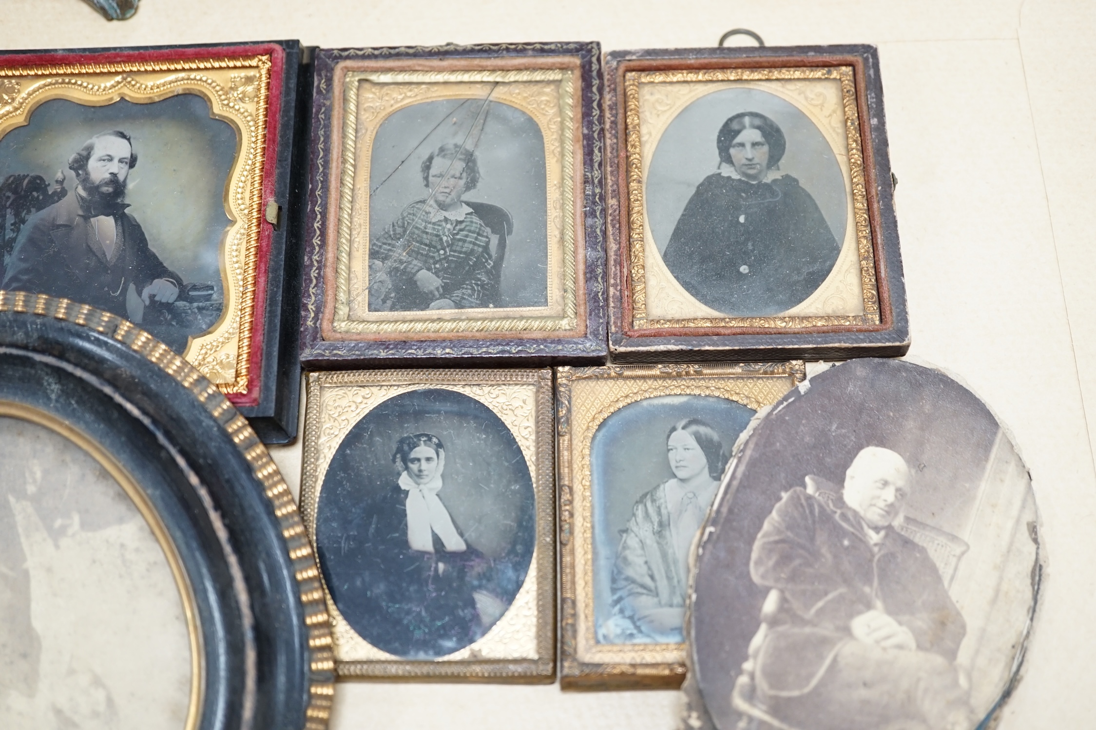 A collection of Victorian ambrotype and black and white photographs including two with original cases, largest 14cm high overall. Condition - poor to fair